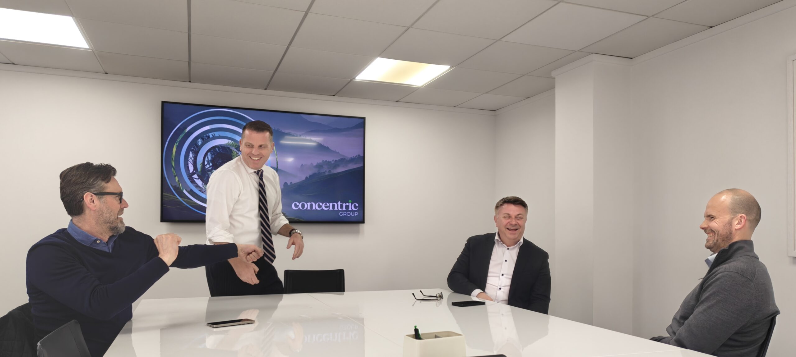 Financial advisers and wealth management professionals meeting in a modern boardroom to discuss the changing international advice model